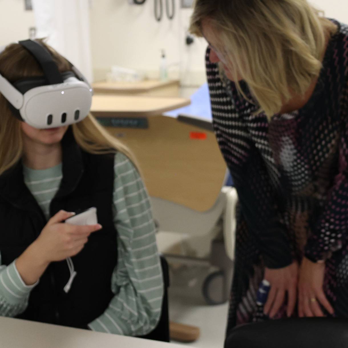 Student and faculty with a VR headset in class